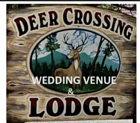 Deer Crossing Lodge sign with a deer and forest background.